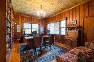a dining room with a table and a couch at Luxury Farmhouse in the Heart of Historic Downtown in Cartersville