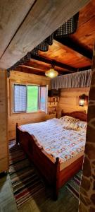 a bedroom with a large bed in a cabin at Naša kuća-Veruša in Veruša
