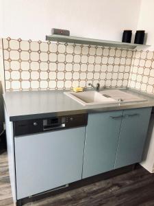 a kitchen with a sink and a counter top at Wohnen wie zuhause - zu Gast in Erfurt in Erfurt