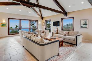 a living room with couches and a tv at Carmel Highlands Home in Carmel