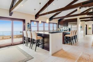 a kitchen with a large island with bar stools at Carmel Highlands Home in Carmel