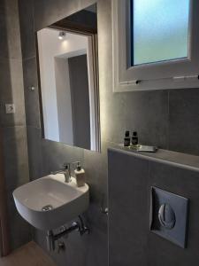 a bathroom with a sink and a mirror at NIKOS DIMAS STUDIOS in Parga +55 photos
