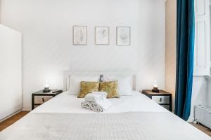 a bedroom with a white bed with two night stands at Lisboa Charming Apartment III in Lisbon
