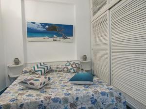 a bedroom with a bed with pillows on it at Piazzetta Sweet Home in Capri