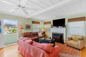 a living room with a couch and a fireplace at Hues and Views in Laguna Beach