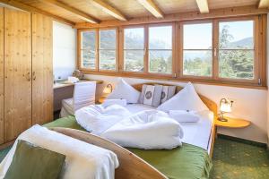 a bedroom with two beds with pillows on them at Pension Lärchenhof in Naturno