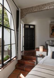 a bedroom with a bed and a large window at Casa Blanca Suite B2 - New, Private, Cozy! in Montecito