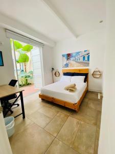 a bedroom with a bed and a desk and a table at Oasis Cali Hostel in Cali +35 photos