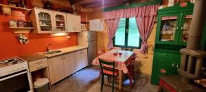 a small kitchen with a table and a sink at Naša kuća-Veruša in Veruša
