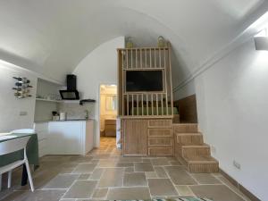 a living room with a staircase with a television at Anacapri in Centro in Anacapri