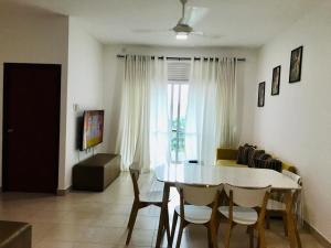 a living room with a table and chairs and a window at Homelike Apartment at Mount Clifford in Homagama