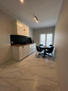 a kitchen and dining room with a table and chairs at Kierunek Górki 