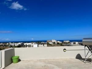 a white wall with a view of the ocean at John House studio No 5 in Flic-en-Flac
