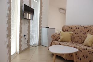 a living room with a couch and a table at Gjinaj Apartments in Ulcinj