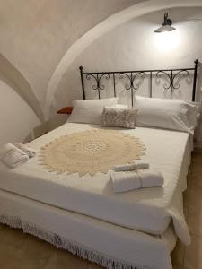 a white bed with two towels on it at Casa Dante - Holiday House in Fasano