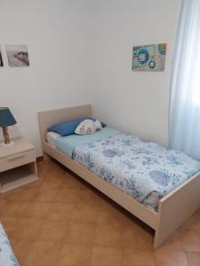a bedroom with a bed and a nightstand and a bed sidx sidx at La casa di Via Musso in Noli