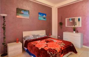 a bedroom with a bed with a red bedspread at Vulcano in Pozzallo