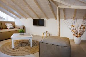 a living room with a couch and a table at Zeyia in Ierissos