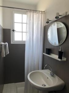 a bathroom with a sink and a window and a mirror at Les Hortensias in Espoey +91 photos