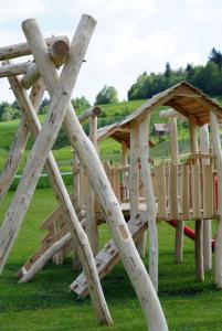 a set of wooden play structures in a field at Cowboy's Land in Višnja Gora