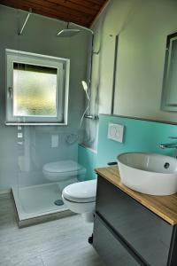 a bathroom with a sink and a toilet and a shower at Chalet Alba in Lichtenberg