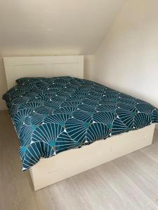 una camera con letto e piumone blu di Bel appartement cosy proche de la frontière Suisse a Villers-le-Lac