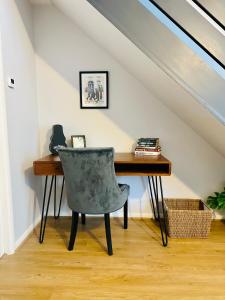 a desk and a chair in a room with a staircase at Townhouse in Derby in Derby
