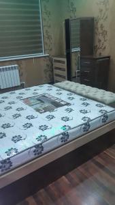 a bedroom with a bed with a floral mattress at Квартира для 5 человек в Нукусе in Nukus