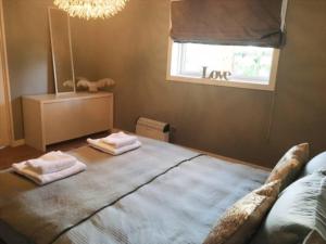 sypialnia z dużym łóżkiem z dwoma ręcznikami w obiekcie Beautiful apartment with bathtub, sauna and gym w Ålesund