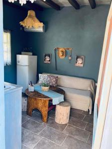 a living room with a table and a refrigerator at LOURA MANI'S 1 in Flomokhórion