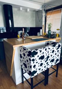 a kitchen with a black and white patterned bar stool at Bovis APARTMENT - Gdynia Center Rezydencja Redłowo in Gdynia