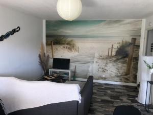 a bedroom with a mural of a beach at T2, bord de plage et piscine in Biscarrosse