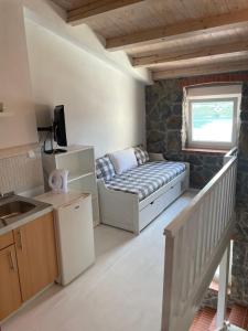 a small room with a bed and a window at Apartments Ela in Neum