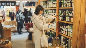 a woman standing in a store looking at bottles of wine at SOKI KANAZAWA - Vacation STAY 40333v in Kanazawa