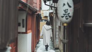 a woman walking down a street in an alley at SOKI KANAZAWA - Vacation STAY 40338v in Kanazawa