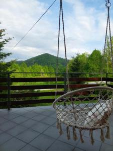 a swing on a porch with a view at Holiday Home Čančarević in Ravna Gora