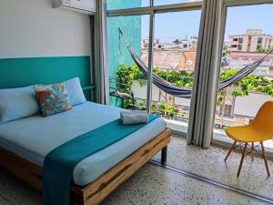 Bona Vida Hotel客房内的一张或多张床位