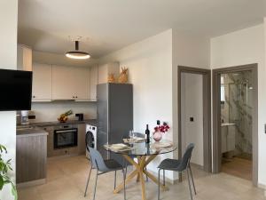 a kitchen with a table and chairs in a kitchen at Mossa City Apartments in Chania Town