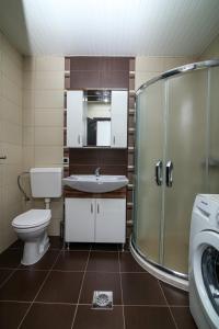a bathroom with a toilet and a sink and a shower at Ohrid City Apartments in Ohrid