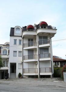 a white building with a red dome on top of it at Ohrid City Apartments in Ohrid