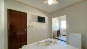 a bedroom with a bed and a door and a mirror at CENTER PLAZA HOTEL in Cristalina