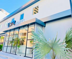 a store front with a palm tree in front of it at URB Hotel in Fortaleza