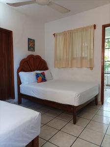 A bed or beds in a room at Hotel Villa Tulipanes