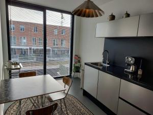 a kitchen with a table and a dining room at Medina B&B hartje Arnhem in Arnhem