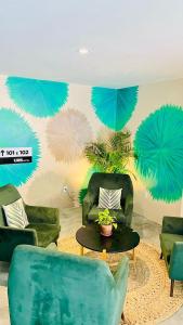 a living room with green chairs and a table at URB Hotel in Fortaleza