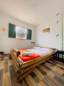 HOTEL LA GAITANA HEROINA INDIGENA في سان أوغستين: غرفة نوم مع سرير خشبي كبير في غرفة