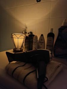 a bathroom counter with a lamp and a towel at Divine Apartment in Plužine