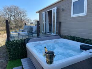 a hot tub on the side of a house at Unwind@37 Lodge in Felton