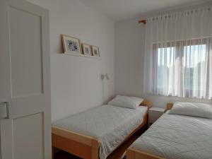 Posteľ alebo postele v izbe v ubytovaní Apartments Vlasici