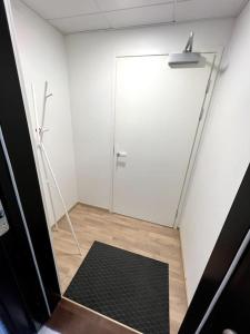 a bathroom with a shower and a black rug at Casa Opaali in Tampere